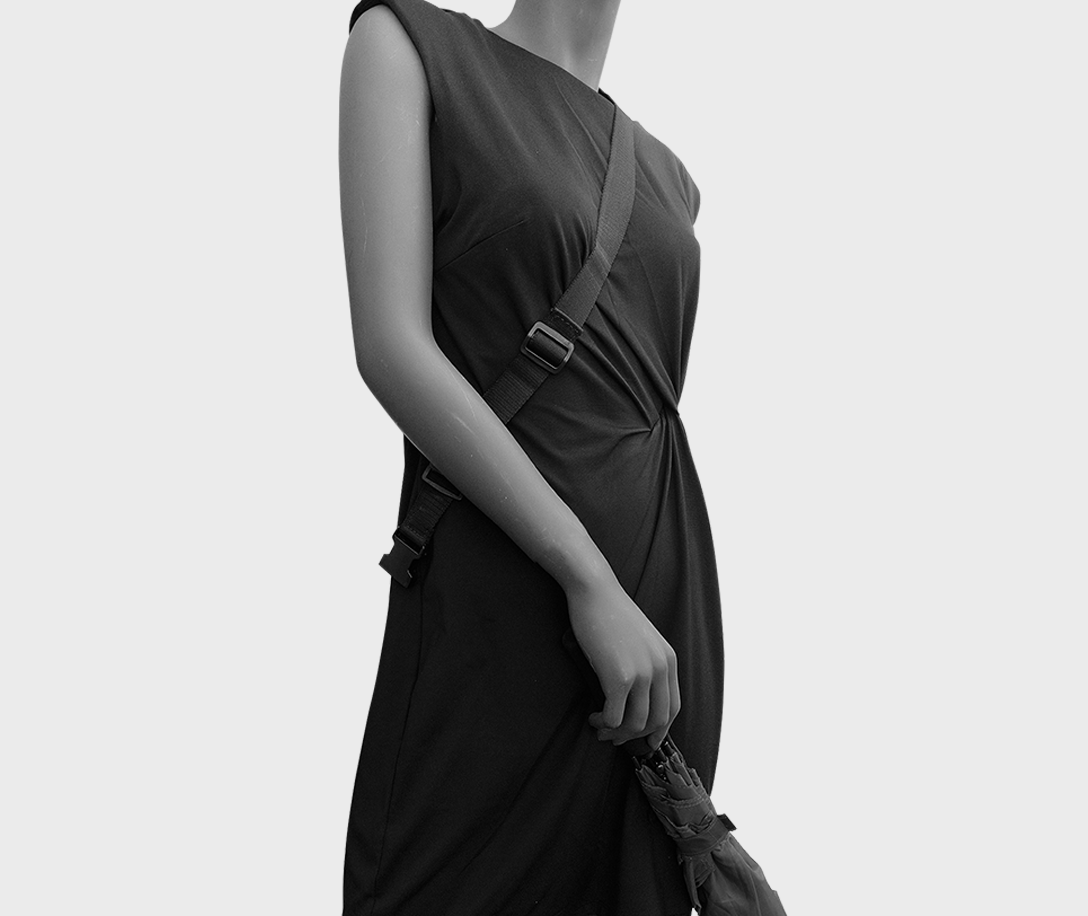Unclip the umbrella from the shoulder strap to use it